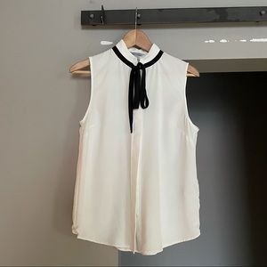 White sleeveless blouse with black silky tie